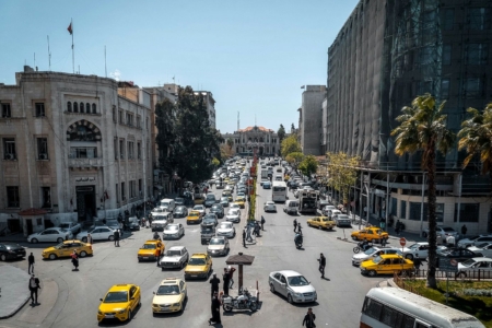 Busy city street with traffic and pedestrians.